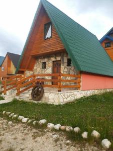 扎布利亚克Holiday Home Vojinovic的小屋设有绿色屋顶和石墙