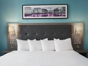 利物浦Leonardo Hotel Liverpool的卧室配有带白色枕头的大床