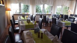 科斯维格Hotel Zur Fichtenbreite -Garni-的餐厅内带桌椅的用餐室