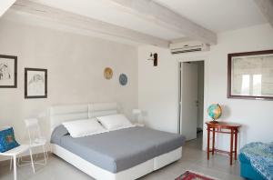 里奥马哲雷内塔勒旅馆的白色卧室配有床和桌子