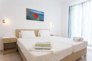 安迪帕罗斯岛Theologos Beach的卧室配有白色床和毛巾