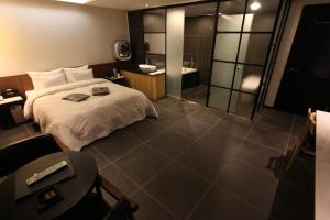仁川市可可酒店的一间带大床的卧室和一间浴室