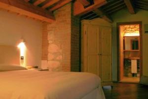 BrendolaTenuta Maraveja的一间卧室配有一张床,一扇门通往一个房间