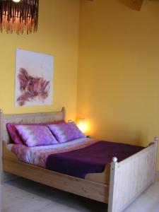 Montorio al VomanoLo Scoiattolo Country House的卧室配有一张黄色墙壁上的床