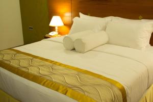 科伦坡独特大厦豪华精品套房酒店的一张配有白色床单和枕头的大床