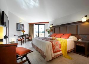 蓬塔米塔Grand Palladium Vallarta Resort & Spa - All Inclusive的酒店客房设有一张大床和一张桌子。