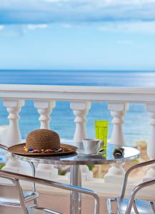 斯法卡基Villa Apollon的海滩阳台桌子上的帽子