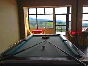 昆达桑水晶山R酒店的窗户间内一张带球的台球桌