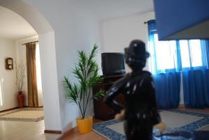 纳扎雷Casa Ana的客厅里一个人的雕像,配有电视