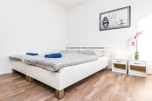 蒙海姆Work & stay Monheim的一间铺有木地板的白色卧室,配有一张床