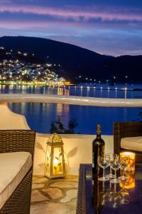 斯科派洛斯Karavos Sea View Apartments的一张桌子,配有酒杯和一瓶葡萄酒