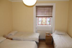 韦茅斯The Weymouth Sea Front Holiday Flat的客房设有两张床和窗户。
