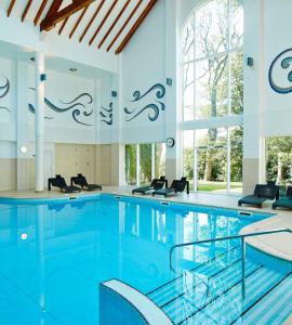 爱丁堡戴玛荷酒店及乡村俱乐部的大楼内的一个蓝色海水游泳池