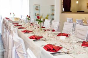 普拉特恩祖尔赛琳娜宾馆的长白桌子,带红色餐巾和眼镜