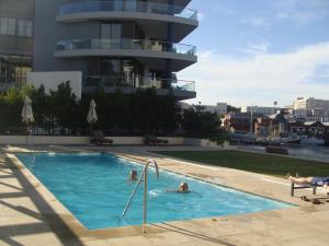 开普敦海滨地区凯尔莫尔A202公寓的两人在大楼的游泳池里
