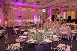 圣斐利-银港多拉达海岸伊波罗之星酒店&度假村的宴会厅配有白色桌椅和紫色照明