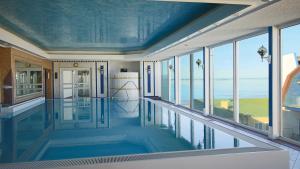 库克斯港斯坦乐酒店的一座带蓝色天花板和窗户的别墅内的游泳池