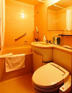 松山松山奈斯特酒店的浴室配有卫生间、盥洗盆和浴缸。