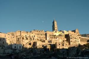 马泰拉Il Nespolo Matera的一座古老的石城,顶部有钟楼
