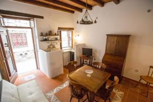 切法卢Bilocale Mandralisca的一间带木桌的客厅和一间厨房