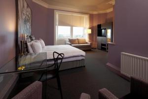 爱丁堡B+B爱丁堡旅馆的酒店客房配有床、桌子和沙发。