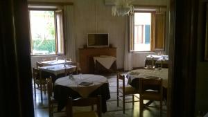 基耶西瑙扎内塞Da Beppe的用餐室设有桌椅和窗户。