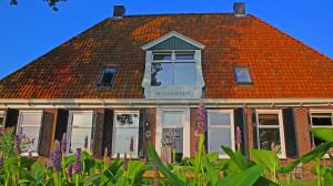 沃尔克姆维尔根住宿加早餐酒店的一座带橙色屋顶的建筑,设有窗户