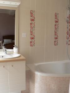 米格龙La Terrasse de la Grand'Rue - chambre d'hôtes -的带浴缸和盥洗盆的浴室