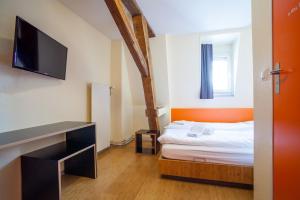巴塞尔easyHotel Basel City - contactless self check-in的小房间设有一张床和一台平面电视