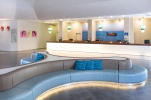提比里亚莱昂纳多俱乐部提比利亚全包型酒店的大楼内带蓝色沙发的客厅