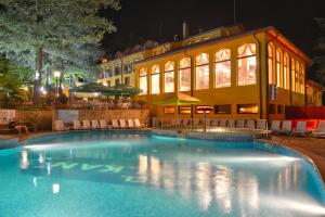 奇夫利克巴尔干酒店的一座游泳池,在晚上在建筑物前