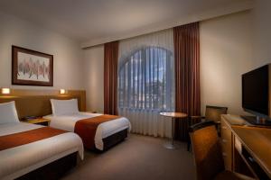 贝斯特韦斯特PLUS旅游酒店客房内的一张或多张床位
