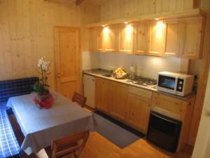 恩特拉奎Campeggio Valle Gesso的厨房配有桌子和微波炉