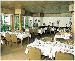 巴特拉尔Landhotel Ridder的一间设有白色桌椅的用餐室