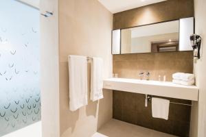 法兰西堡西蒙酒店的一间带水槽和镜子的浴室
