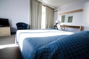 塔尔奎尼亚赫利俄斯大酒店的酒店客房,配有床和电视