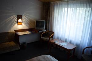 德拉格祖尔赛车道酒店的酒店客房设有电视和带椅子的书桌