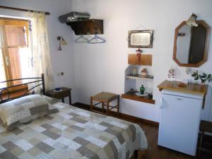 阿伊埃斯拉伦蒂欧斯Sarafis Guesthouse的一间卧室配有一张床和镜子