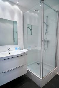吕贝克姆勒特赫酒店的带淋浴和盥洗盆的白色浴室