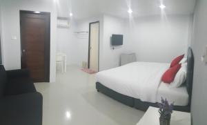 南邦南邦三叶草旅馆的白色卧室配有床和沙发