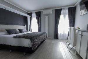 马德里马德里奥威奈特旅馆的一间卧室设有一张大床和两个窗户。