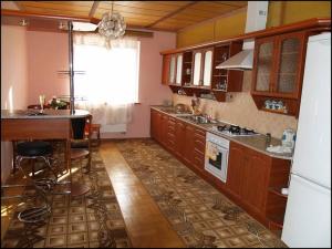 利沃夫Apartament Sanitarna 17的厨房配有木制橱柜、桌子和柜台。