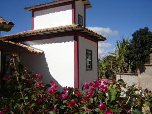 拉夫拉斯诺瓦斯Pousada Villa Verde的白色的小建筑,花粉红色