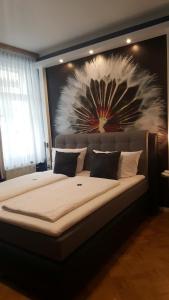 巴特索登-阿伦多夫维拉塔尔酒店的卧室配有一张大床,墙上挂有绘画作品