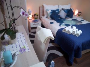 科尔丘拉Marina Guesthouse的一间卧室配有蓝色和白色的床和两张桌子