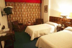 帕伦西亚芒克卢斯酒店的酒店客房设有两张床和窗户。