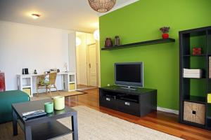 丰沙尔Casa do Cavacas的客厅设有绿色的墙壁和电视。