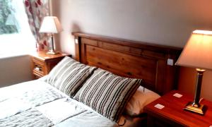 伦维尔奥森住宿加早餐旅馆的一间卧室配有一张床和一张带台灯的桌子