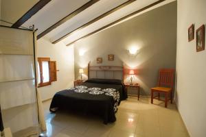 塞戈尔韦Complejo Rural La Belluga的一间卧室配有床和两张桌子及椅子