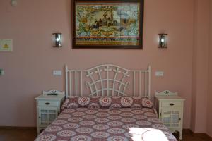 埃尔罗西奥托鲁诺餐厅及酒店的卧室配有一张床,墙上挂着一幅画